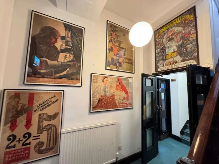 Original site photograph of MML’s corridor and poster displays, without new signage overlays.