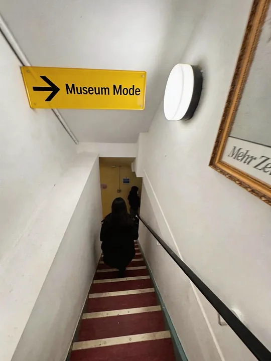 Proposed Museum Mode signage composited onto my site photograph of the MML staircase, with AI-assisted overlays.