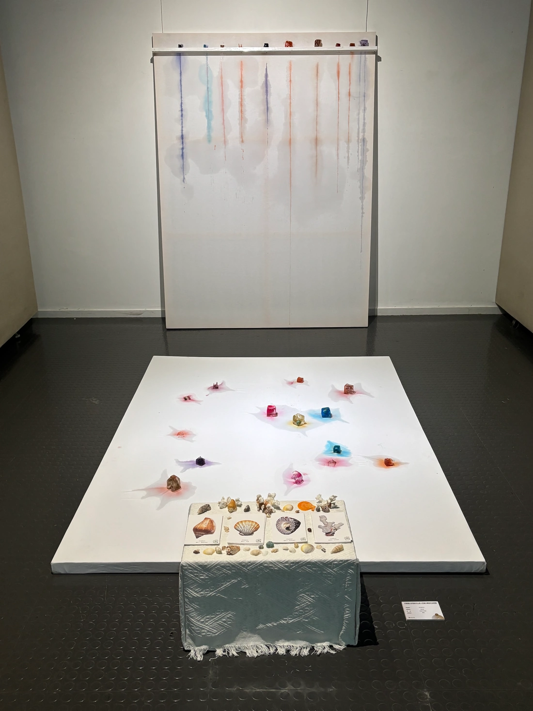 Hanging canvas, floor installation and postcard table at an early stage