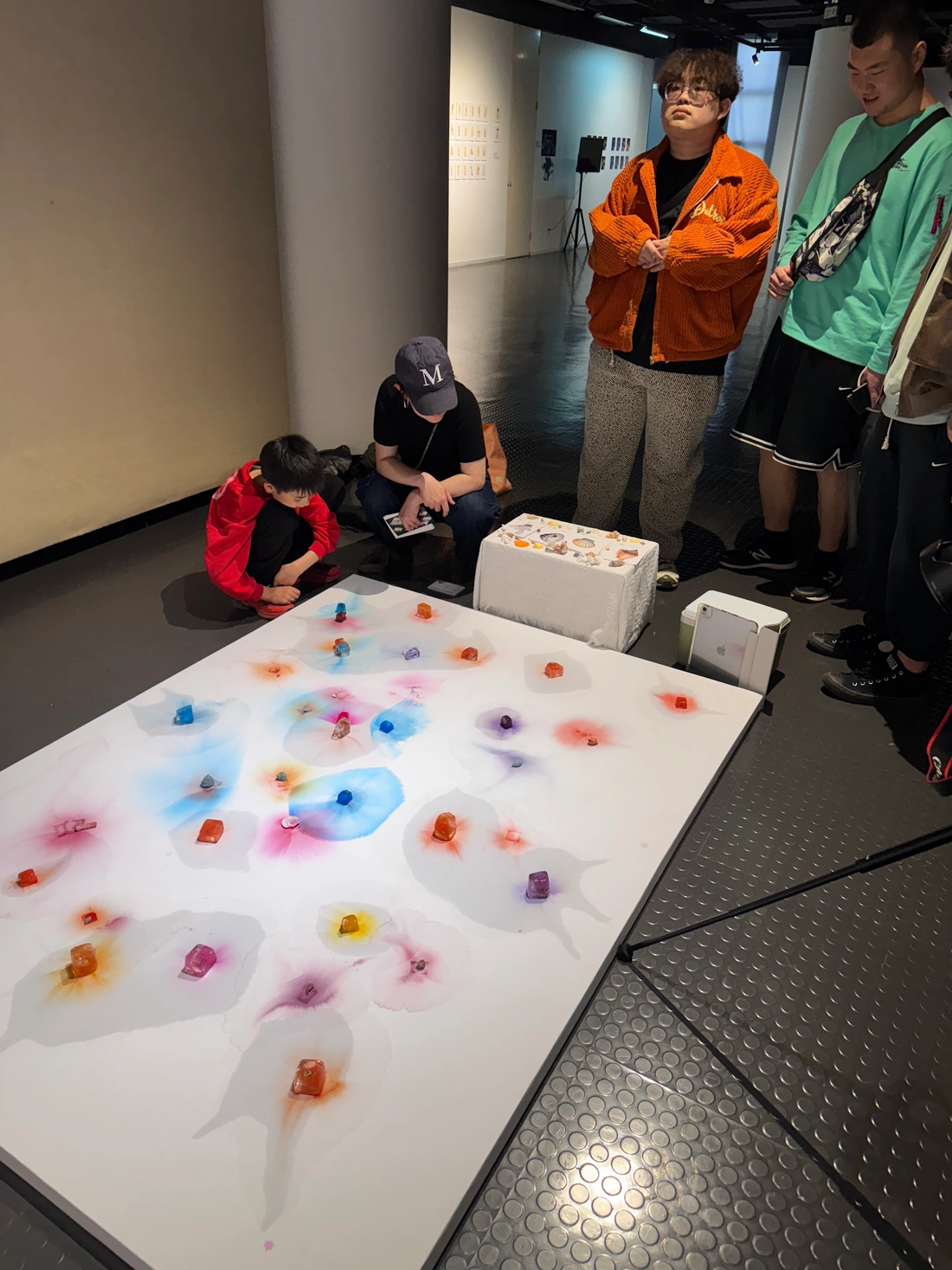 Visitors gathered around the horizontal installation