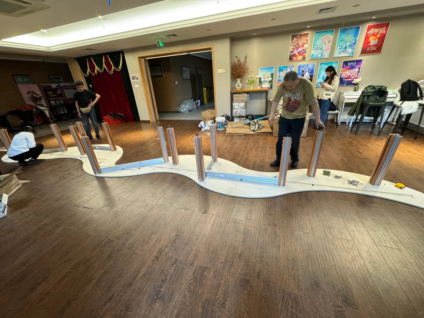 The team assembling the curved table on site, before projection setup.